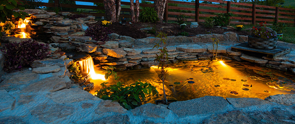 Landscape lighting added to a pond installed for a property in Haslett, MI.