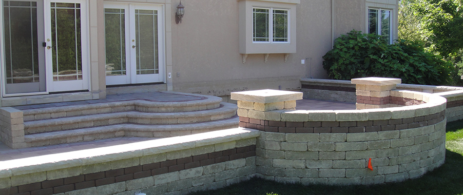 A seating wall installed by a patio in DeWitt, MI.
