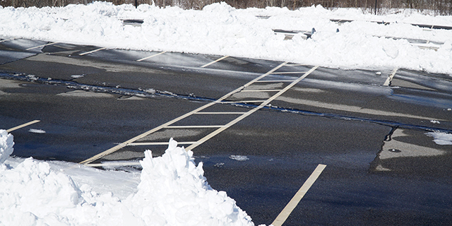 Snowy parking lot cleared in East Lansing, MI.