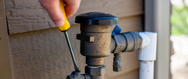 content-technician-performing-irrigation-startup